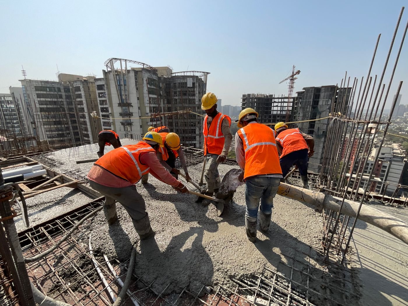 Team performing concrete work on a multistorey building